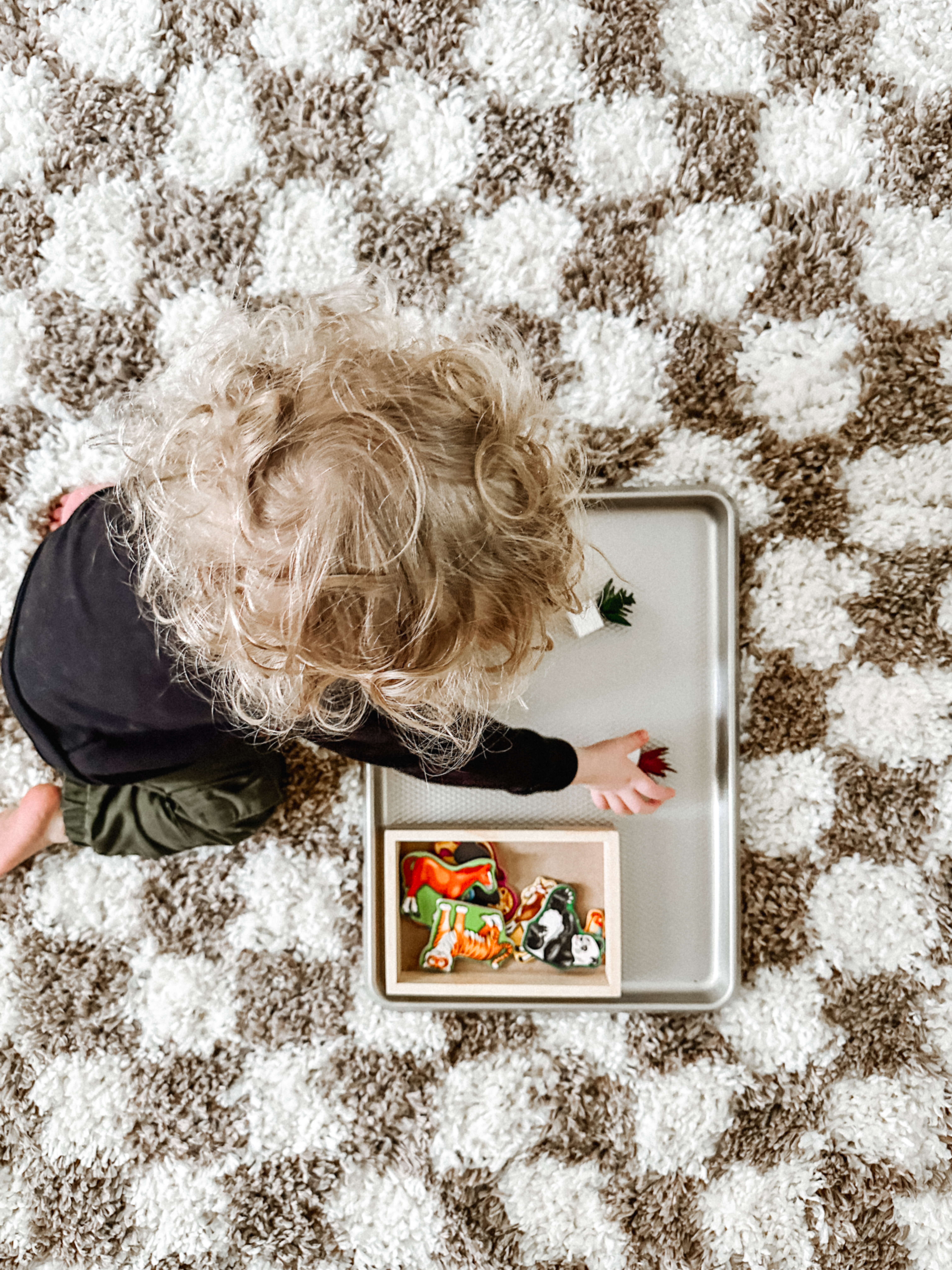 Sensory Play Activity: Magnetic Baking Sheet Toddler playing with magnetics on baking sheet.
