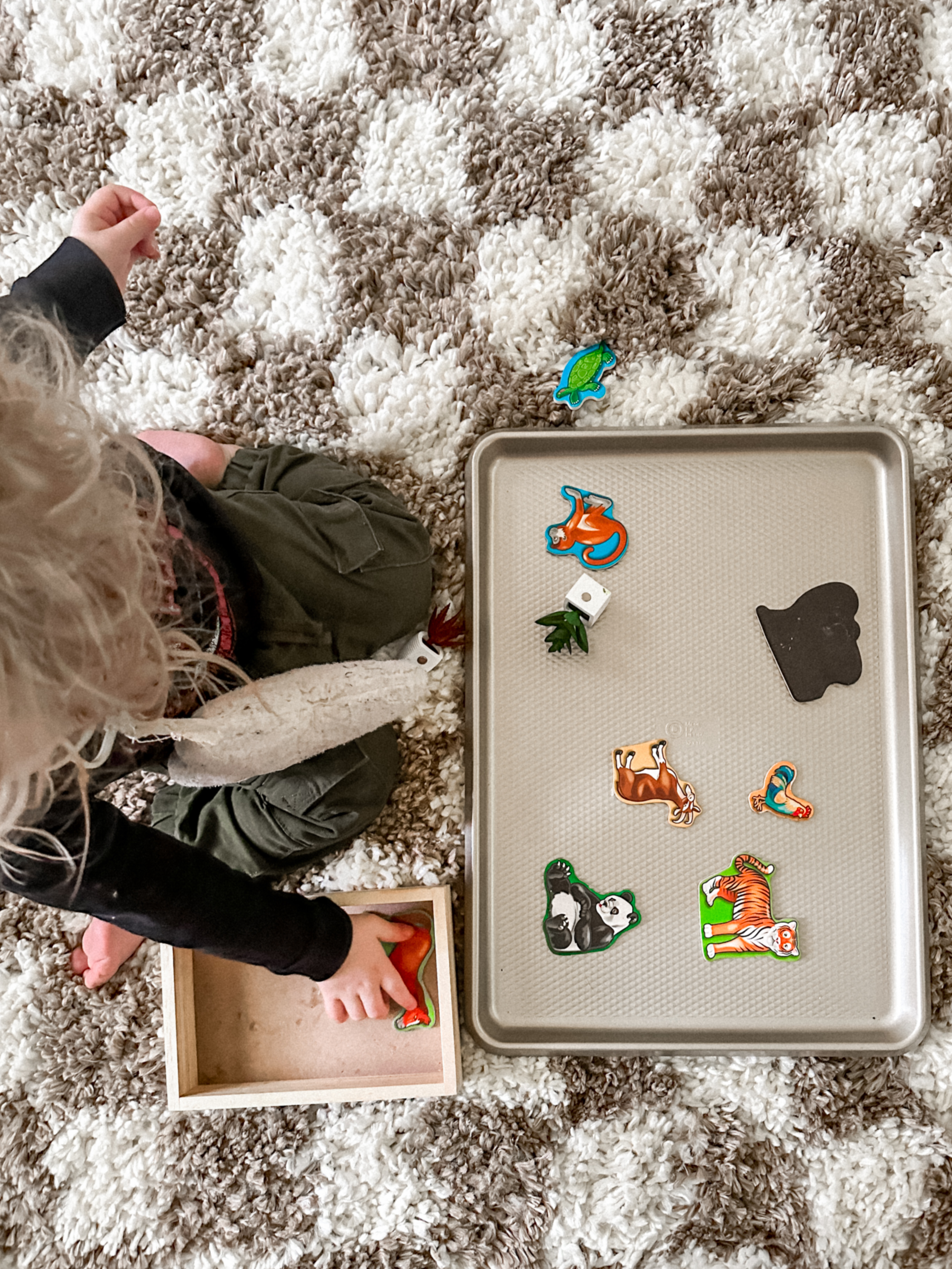 Sensory Play Activity: Magnetic Baking Sheet Toddler playing with magnetics on baking sheet.